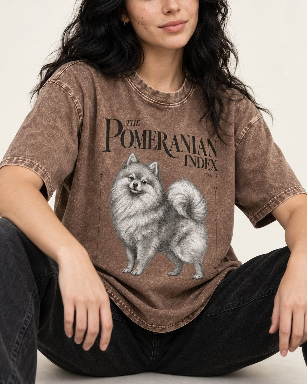 The Pomeranian Index Washed Tee in Coffee, worn by a seated model