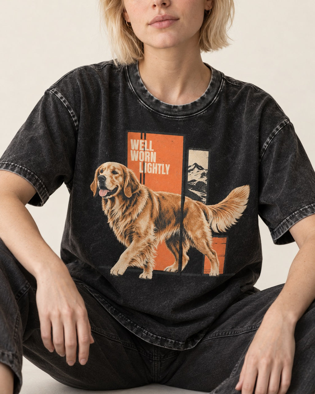 Golden Retriever Well Worn Lightly Mountain Graphic Washed Tee in Black, worn by a seated model