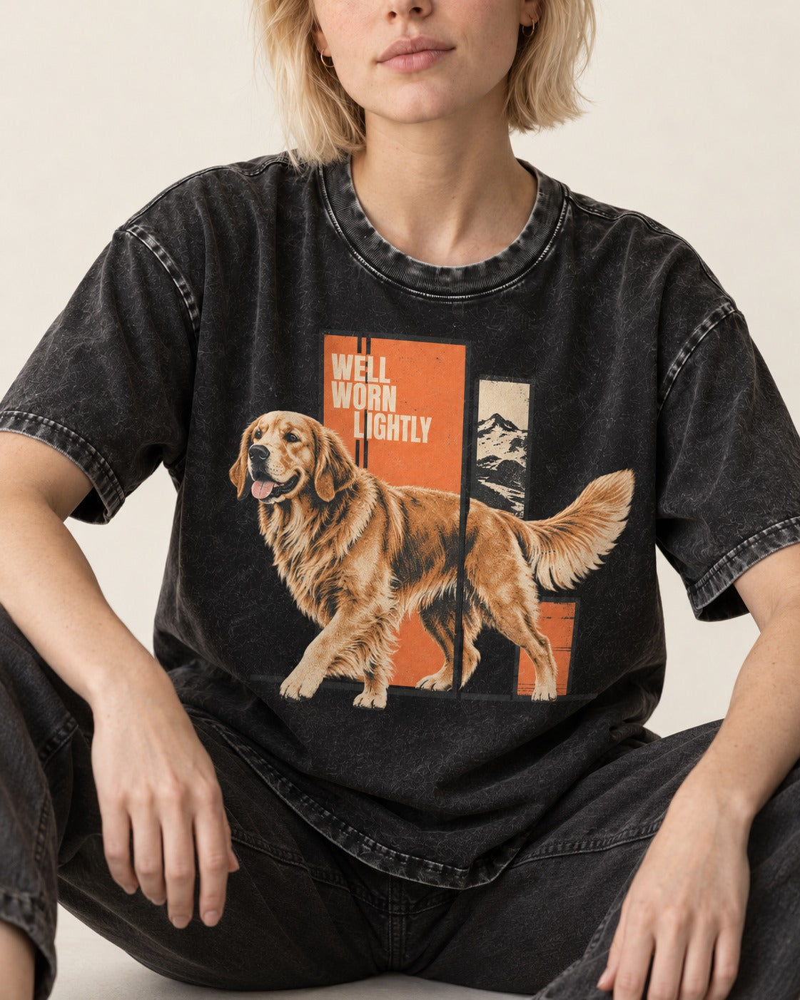 Golden Retriever Well Worn Lightly Mountain Graphic Washed Tee in Black, worn by a seated model