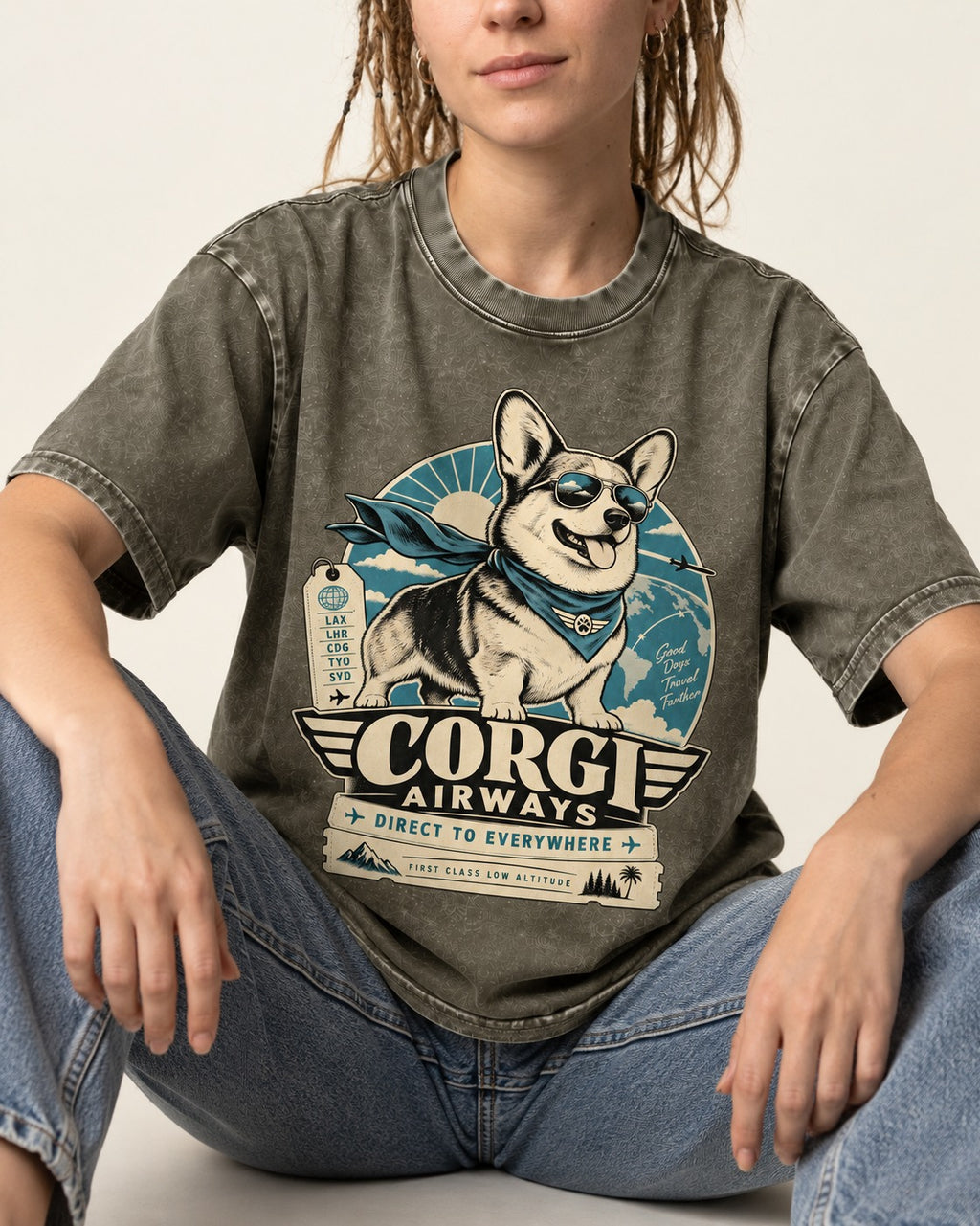 Corgi Airways Direct to Everywhere Badge Washed Tee in Army Green, worn by a seated model
