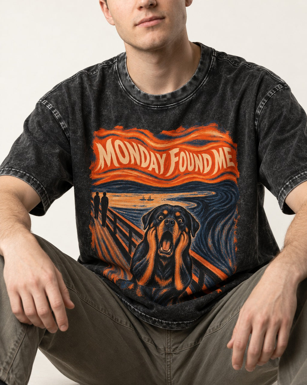 Rottweiler Monday Found Me Scream Parody Graphic Washed Tee in Black, worn by a seated model