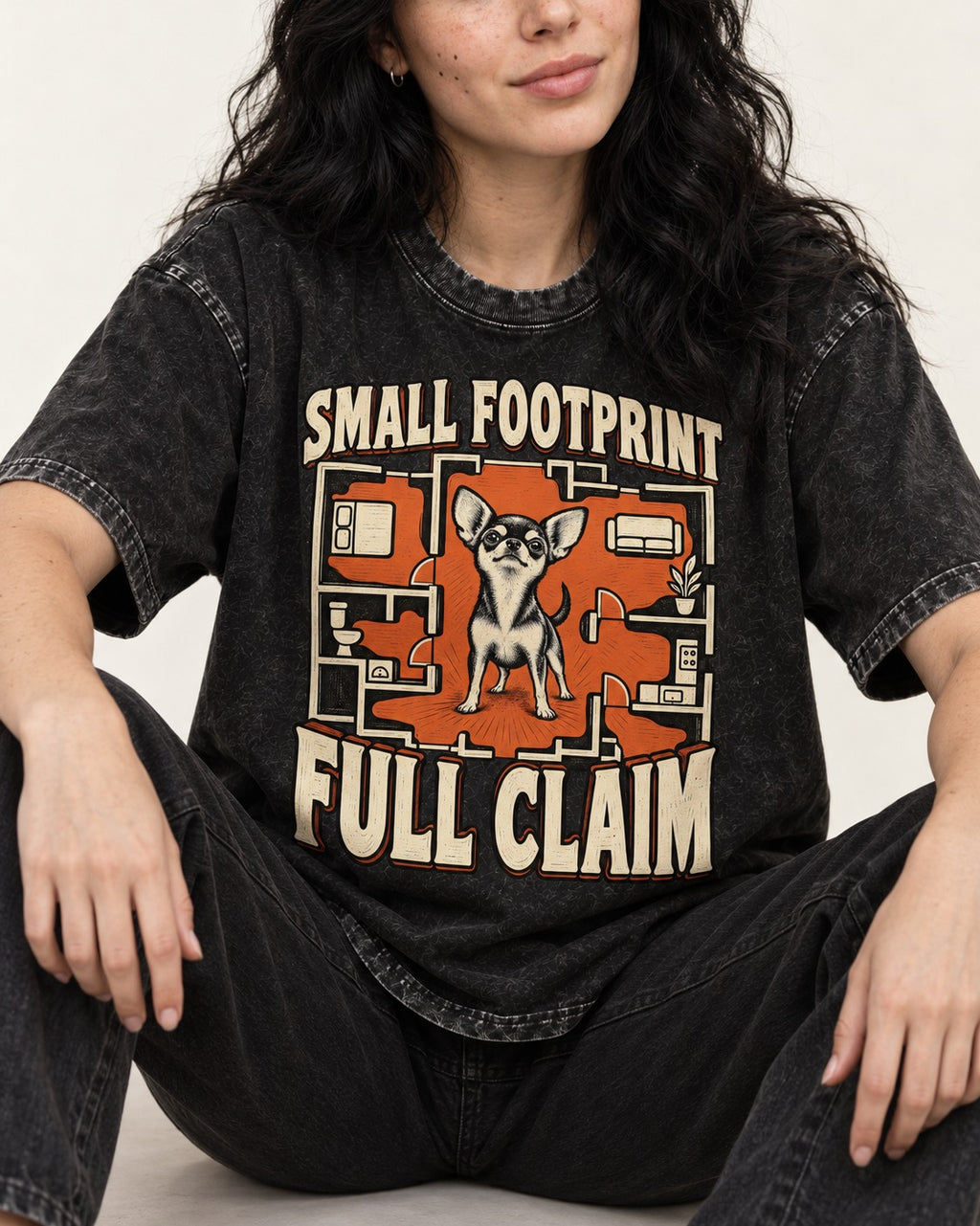 Chihuahua Small Footprint Full Claim Floor Plan Graphic Washed Tee in Black, worn by a seated model