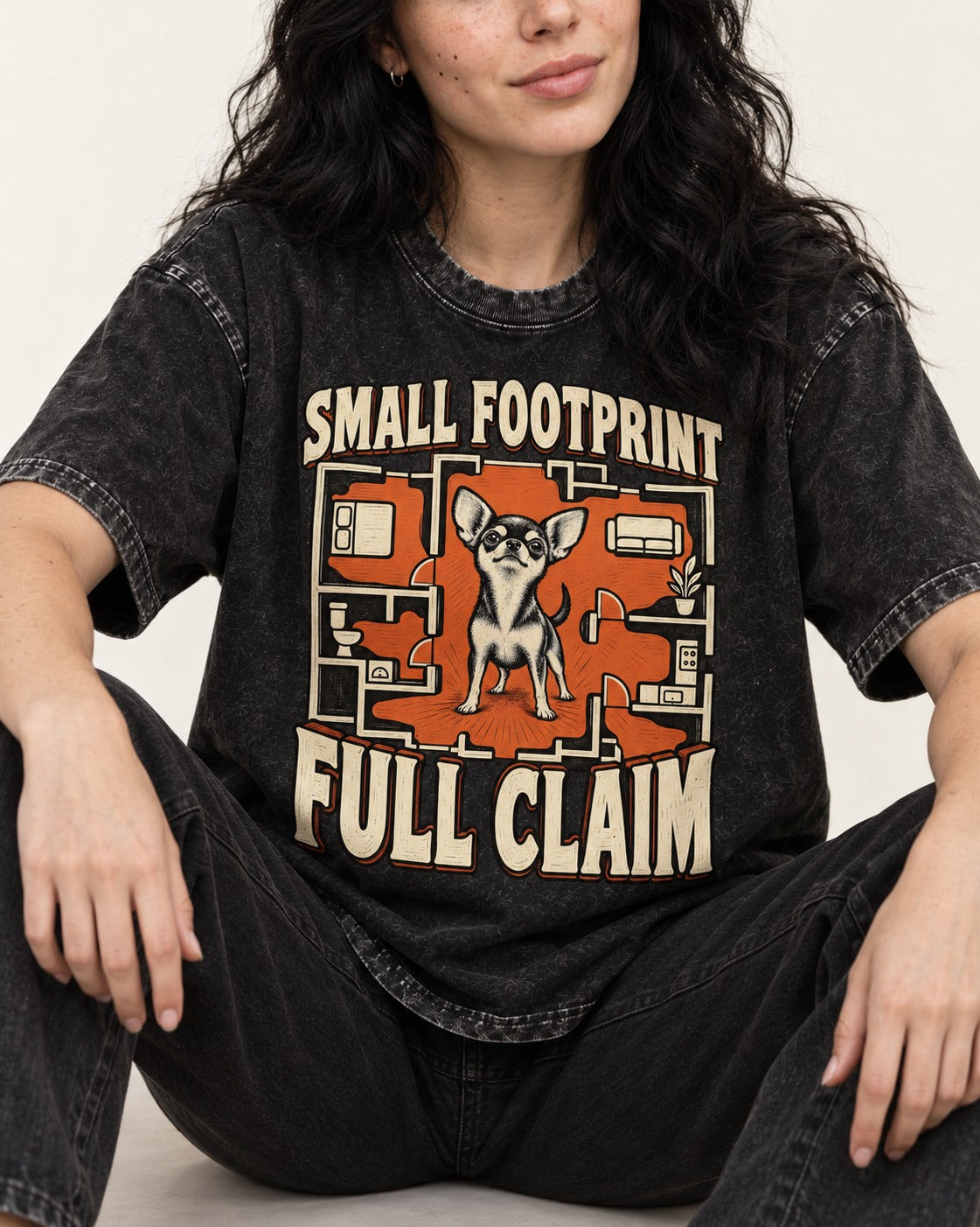 Chihuahua Small Footprint Full Claim Floor Plan Graphic Washed Tee in Black, worn by a seated model