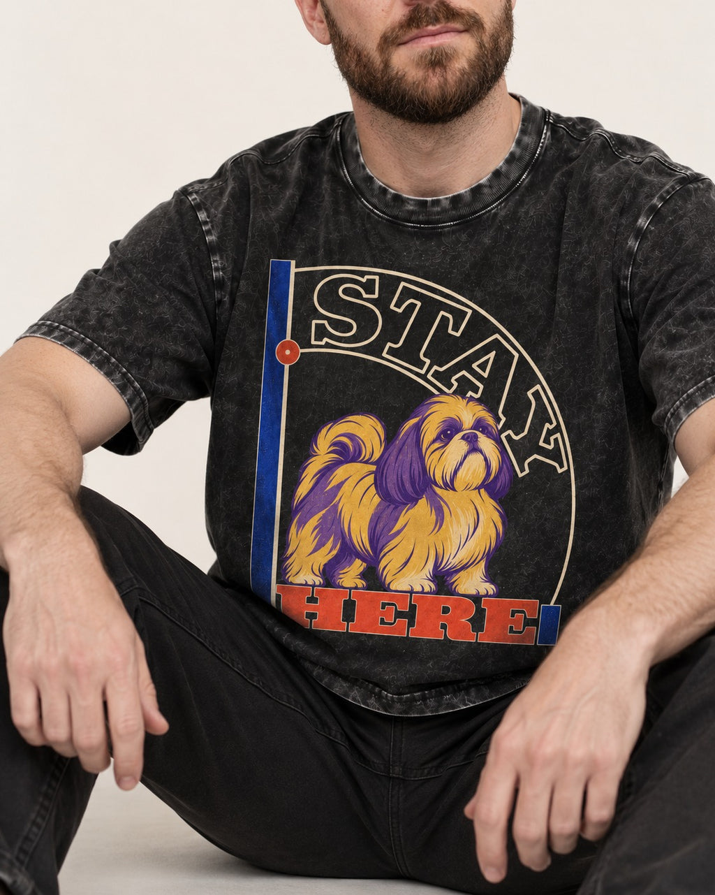 Shih Tzu Stay Here Semicircle Sign Graphic Washed Tee in Black, worn by a seated model