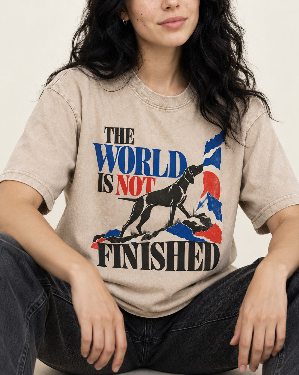 World Is Not Finished German Shorthaired Pointer Washed Tee in Apricot, worn by a seated model