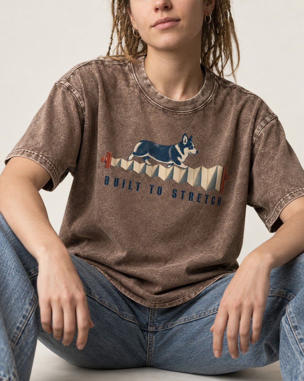 Corgi Built to Stretch Accordion Graphic Washed Tee in Coffee, worn by a seated model