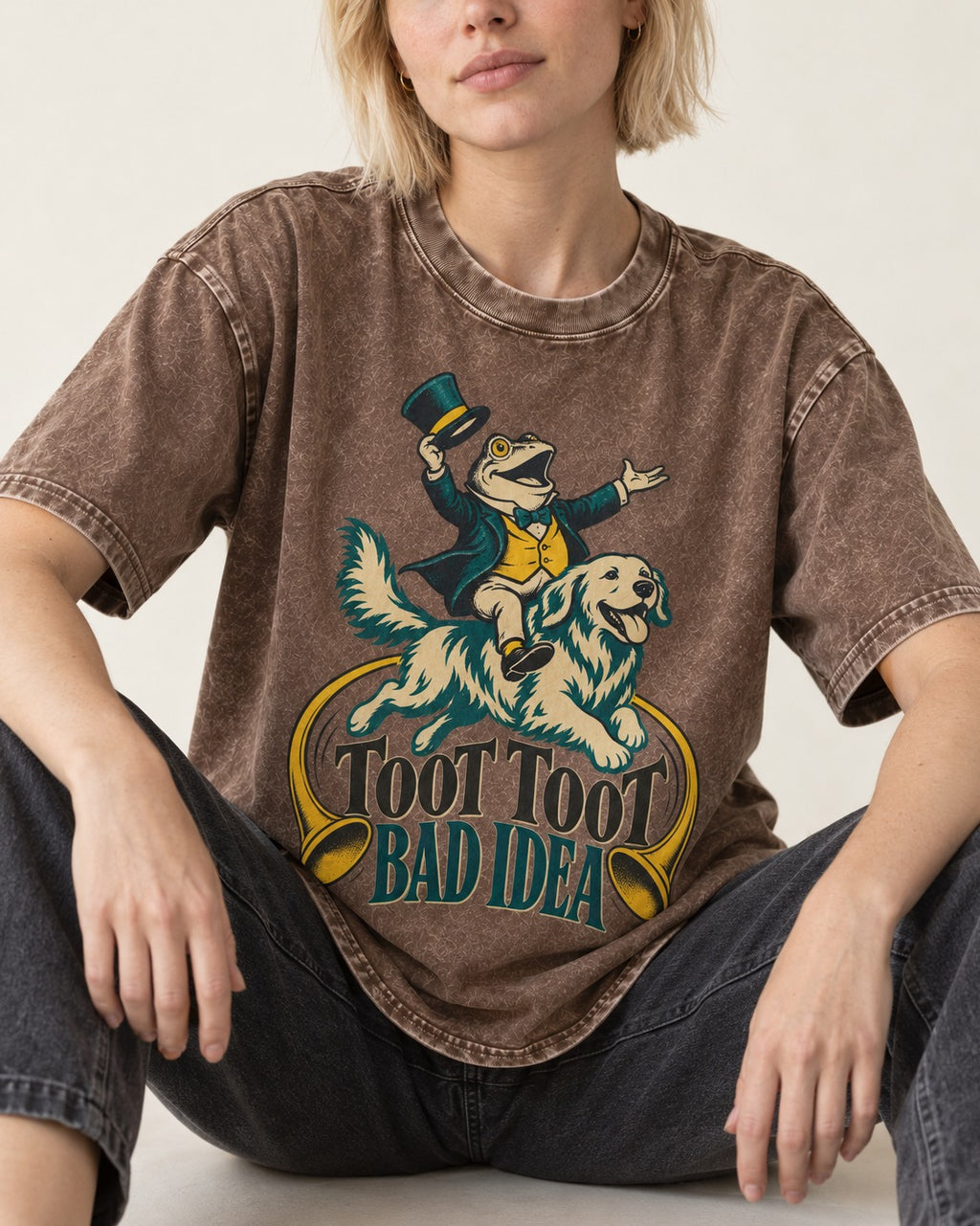 Golden Retriever Toot Toot Bad Idea Washed Tee in Coffee, worn by a seated model