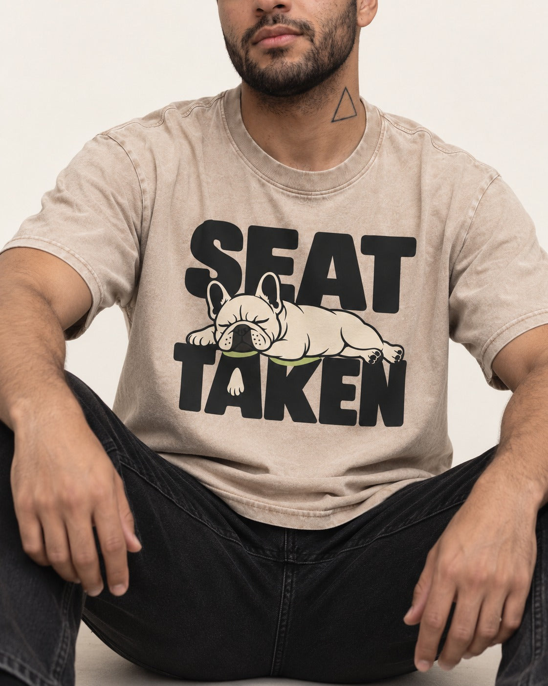 Seat Taken by Frenchie Washed Tee in Apricot, worn by a seated model
