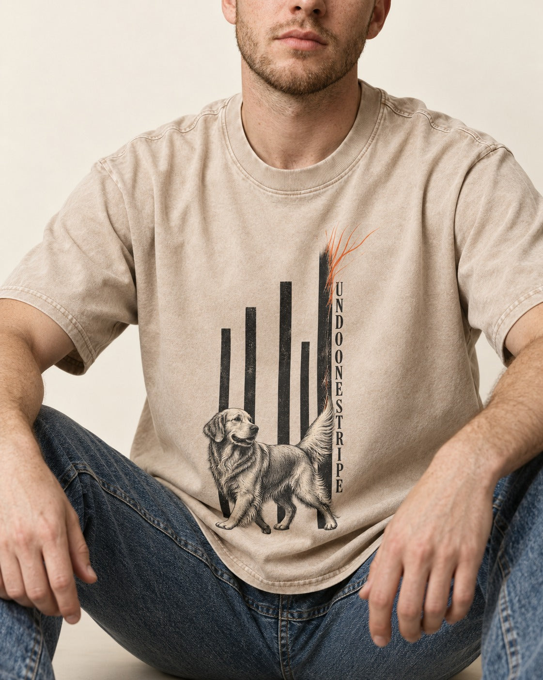 Undo One Stripe Golden Retriever Washed Tee in Apricot, worn by a seated model
