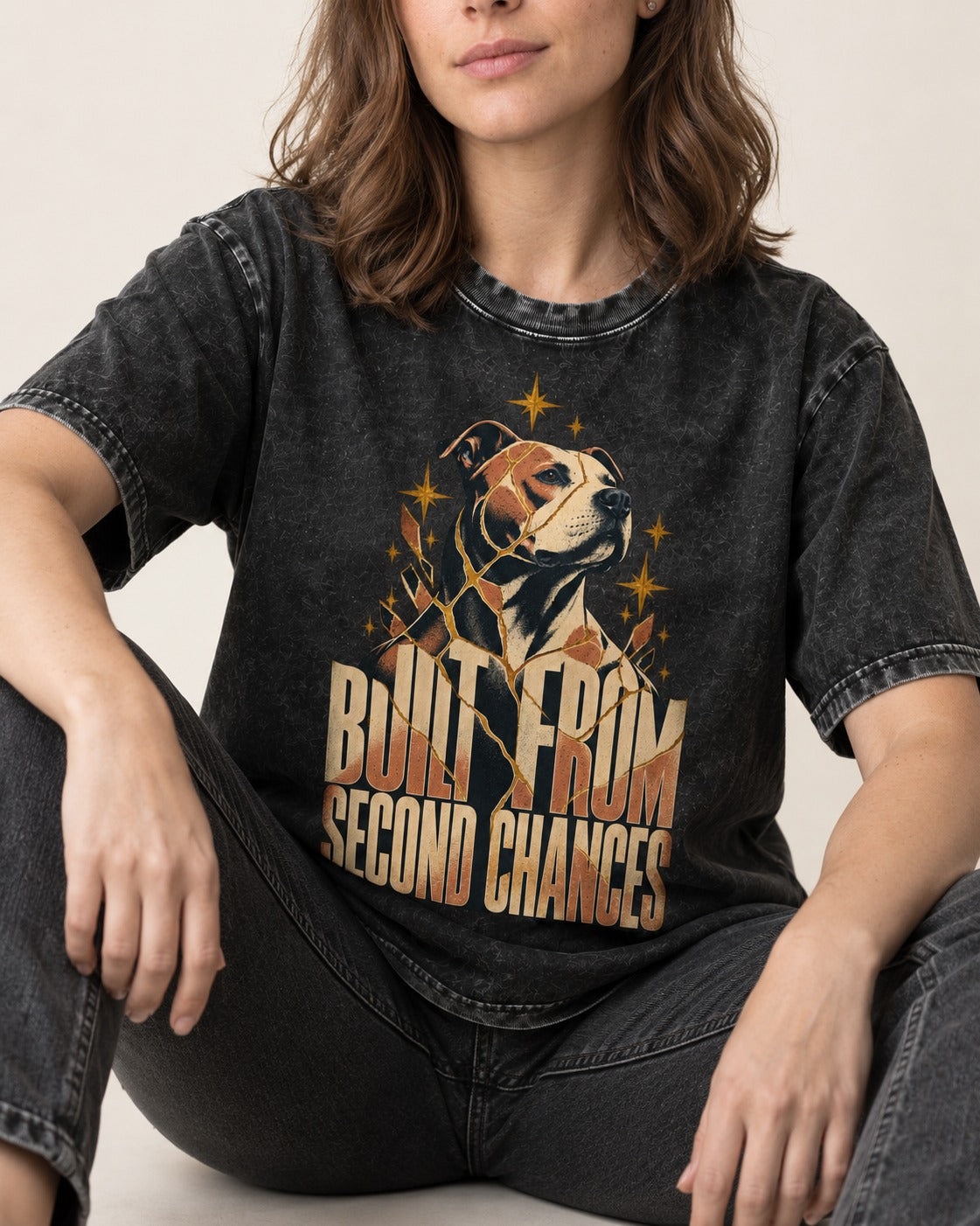 Pitbull Built from Second Chances Kintsugi Graphic Washed Tee in Black, worn by a seated model
