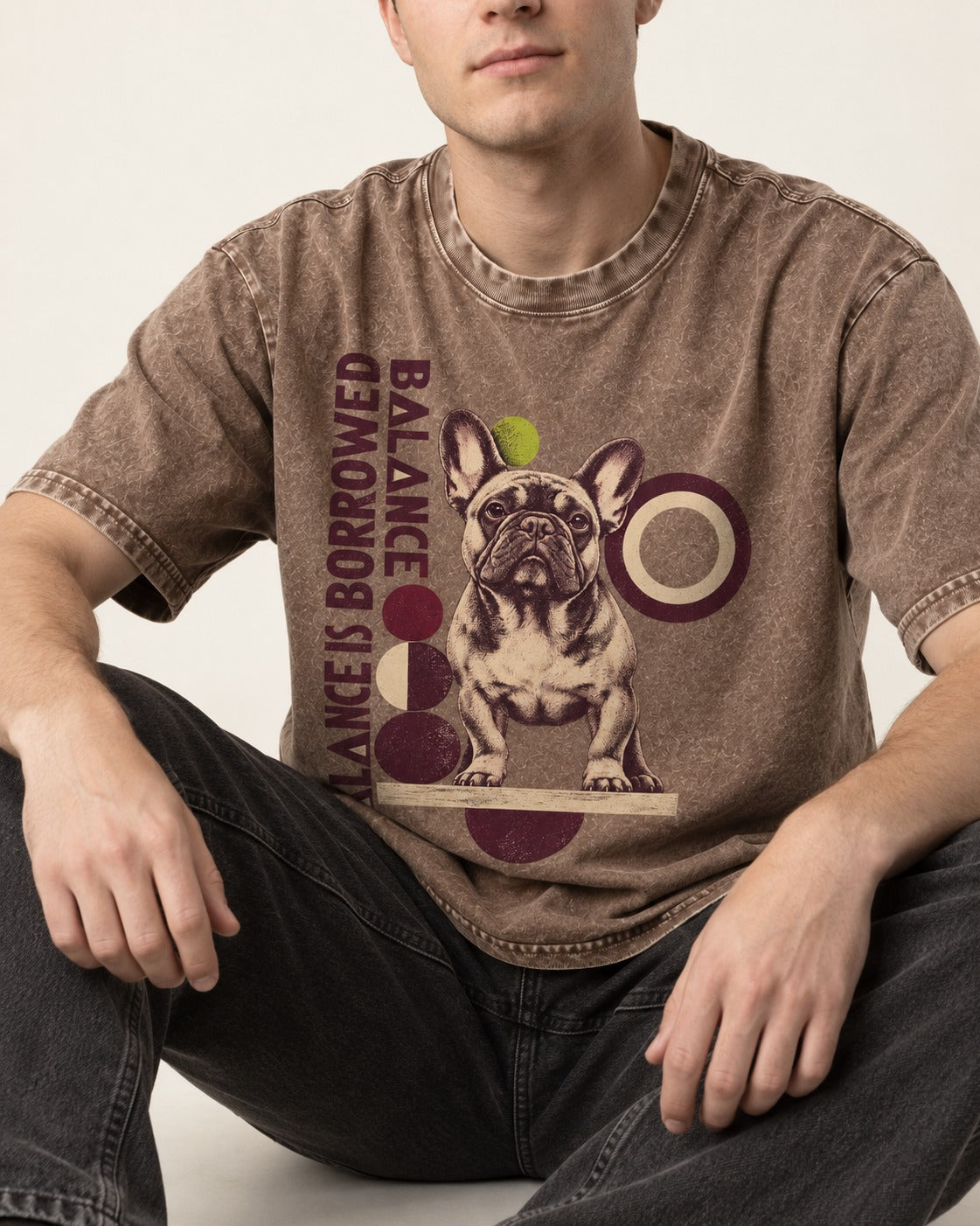 Frenchie's Balance Is Borrowed Washed Tee in Coffee, worn by a seated model