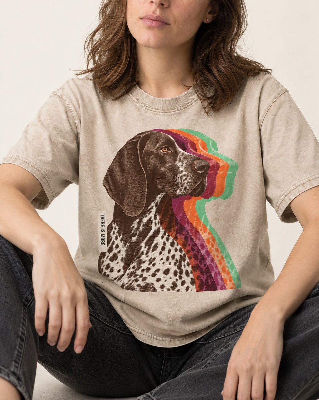 There Is More German Shorthaired Pointer Washed Tee in Apricot, worn by a seated model
