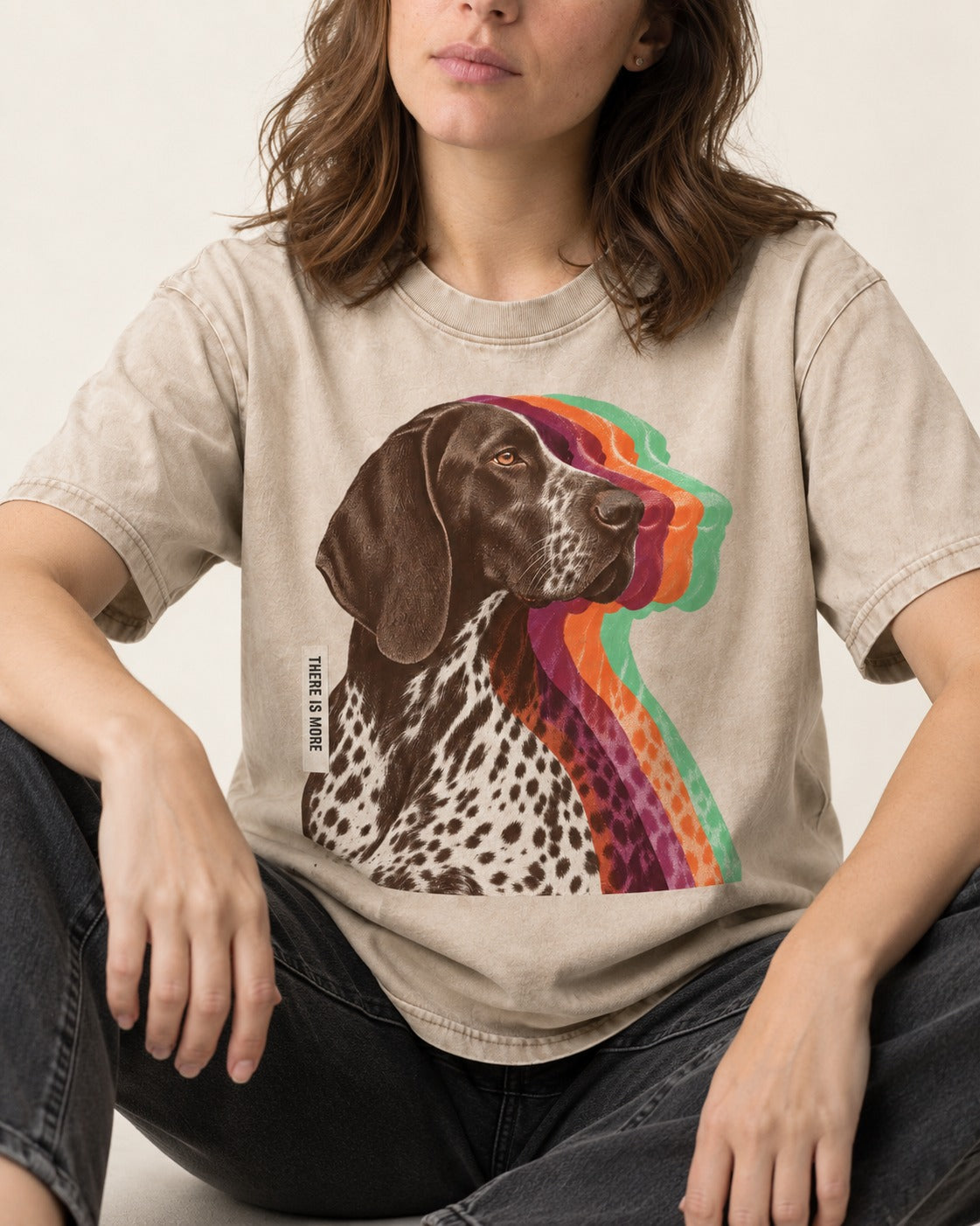 There Is More German Shorthaired Pointer Washed Tee in Apricot, worn by a seated model