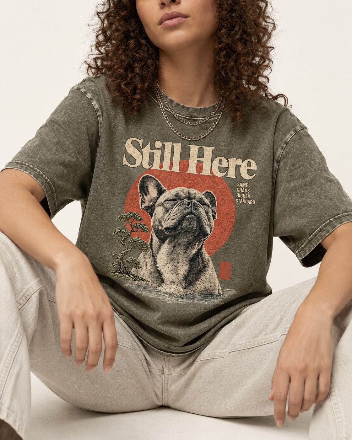 Frenchie Still Here Bonsai Portrait Graphic Washed Tee in Army Green, worn by a seated model