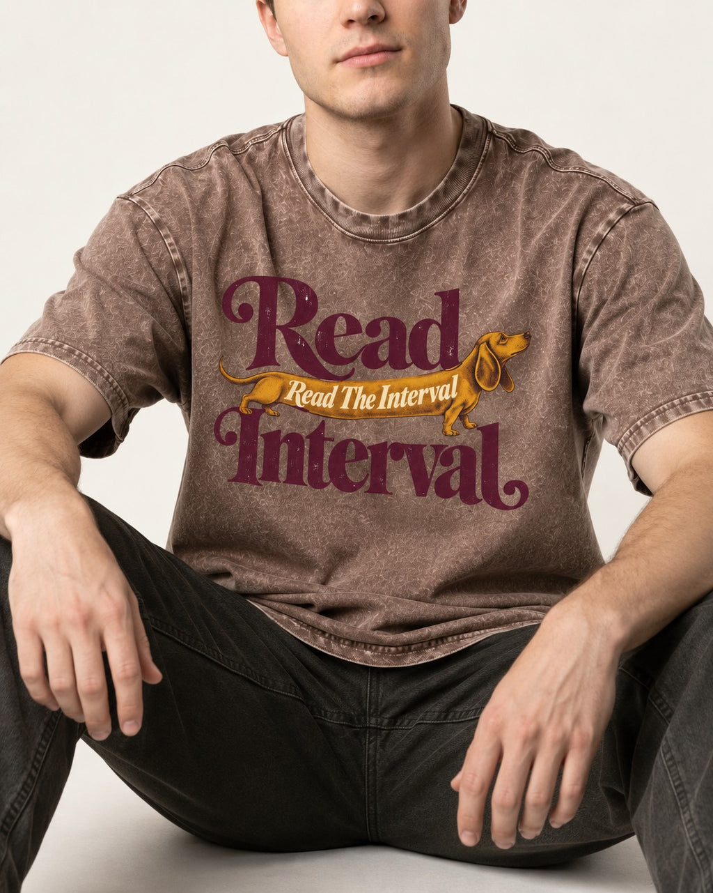 Read the Dachshund Interval Washed Tee in Coffee, worn by a seated model