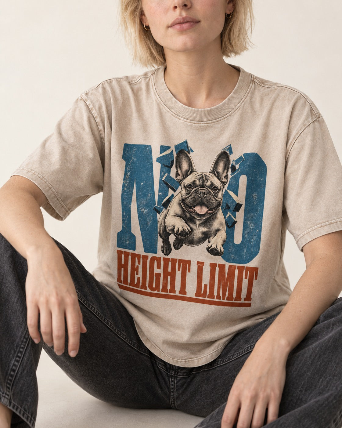 No Height Limit Frenchie Washed Tee in Apricot, worn by a seated model