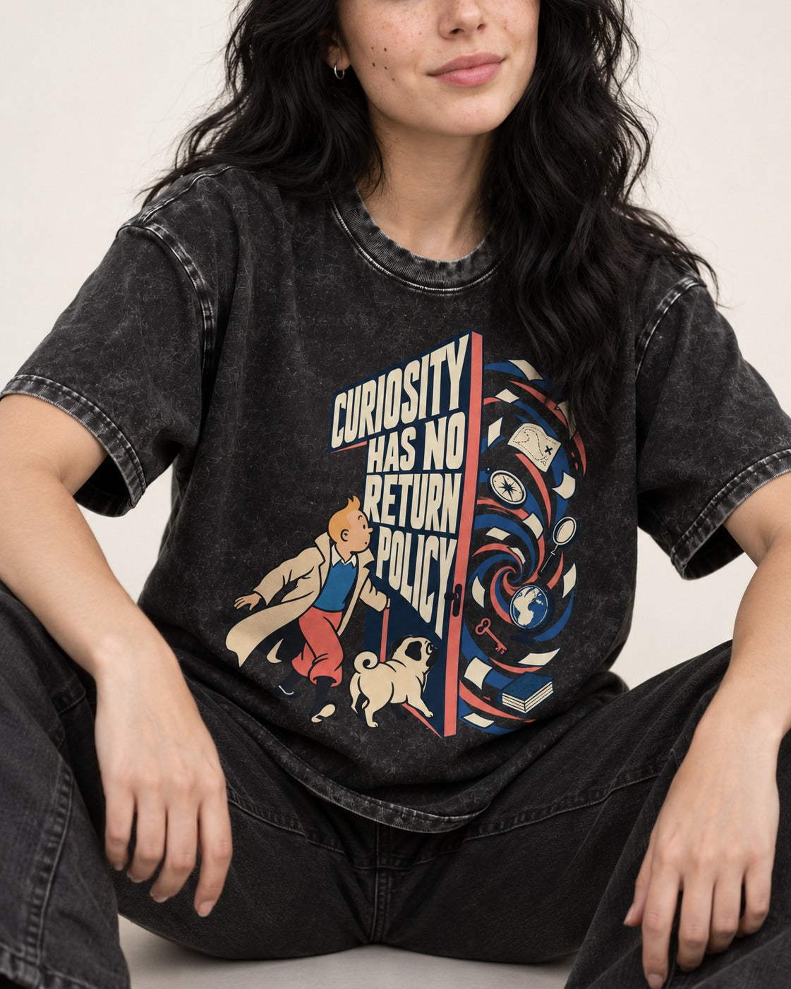 Pug Curiosity Has No Return Policy Portal Graphic Washed Tee in Black, worn by a seated model