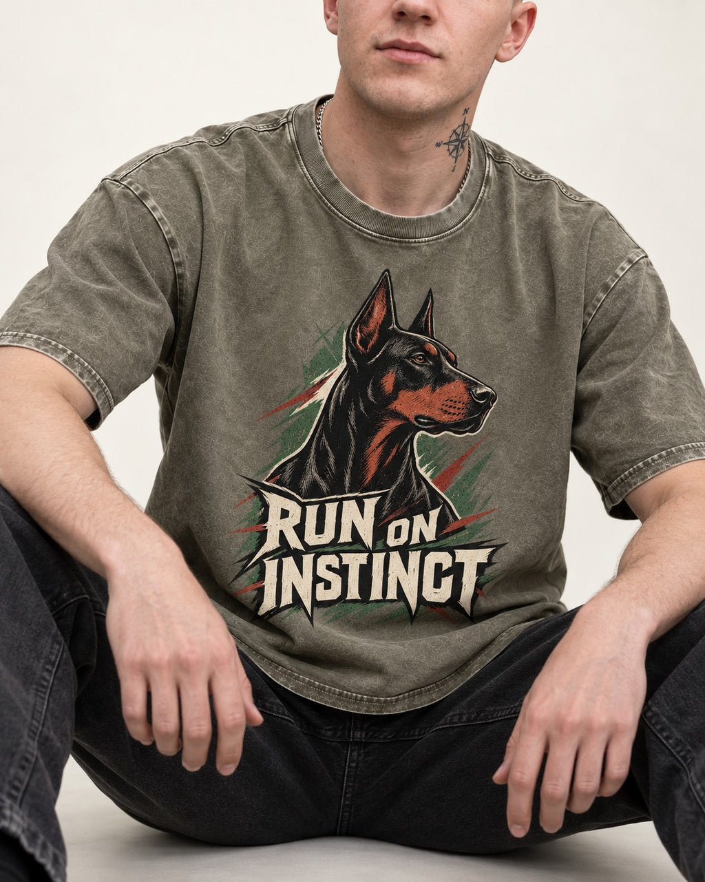 Doberman Run on Instinct Brush Slash Graphic Washed Tee in Army Green, worn by a seated model