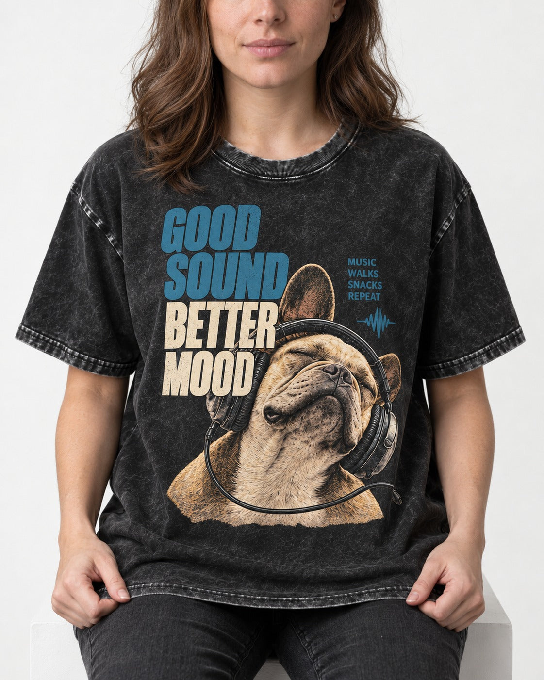 Frenchie Good Sound Better Mood Headphones Graphic Washed Tee in Black, worn by a seated model