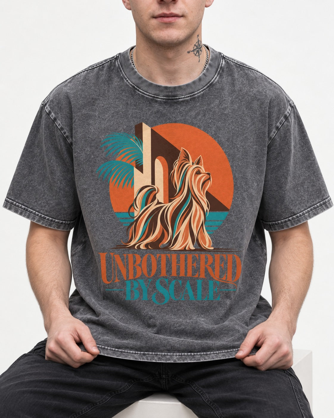Yorkshire Terrier Unbothered by Scale Tropical Architecture Graphic Washed Tee in Gray, worn by a seated model