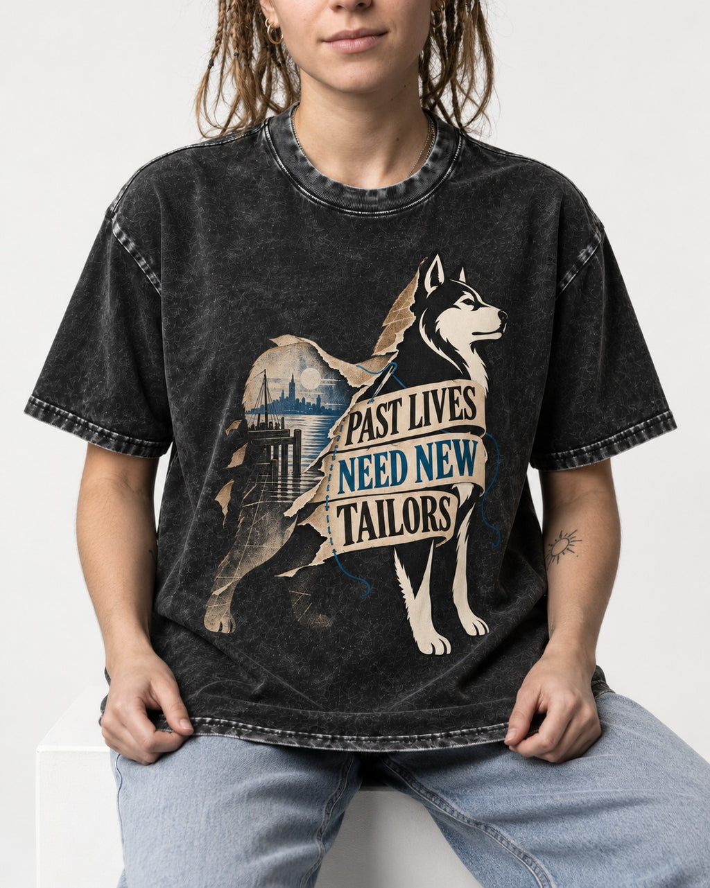 Husky Past Lives Need New Tailors Split Identity Graphic Washed Tee in Black, worn by a seated model