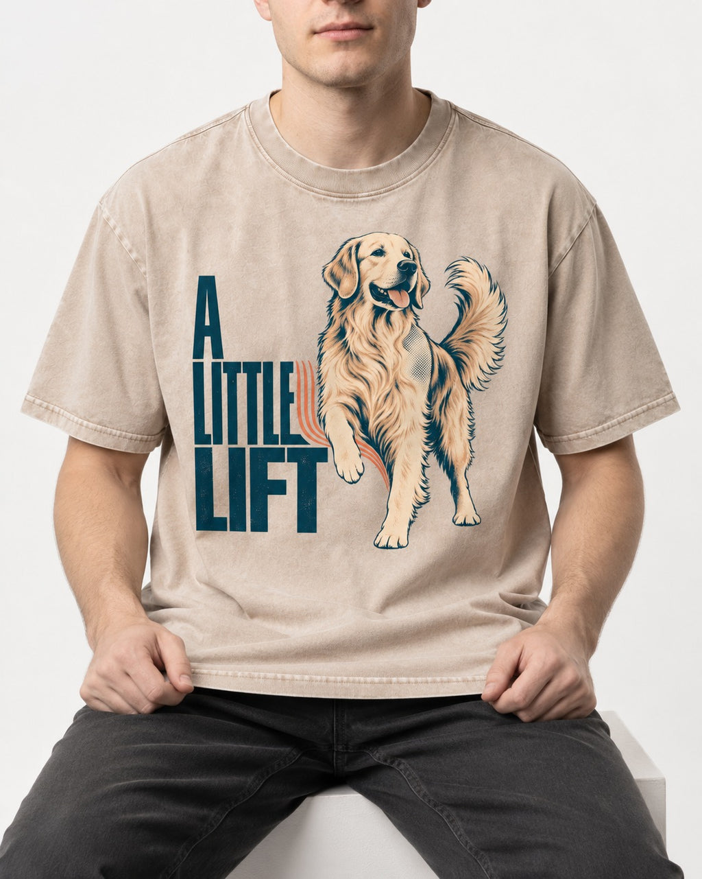 A Little Lift Golden Retriever Washed Tee in Apricot, worn by a seated model