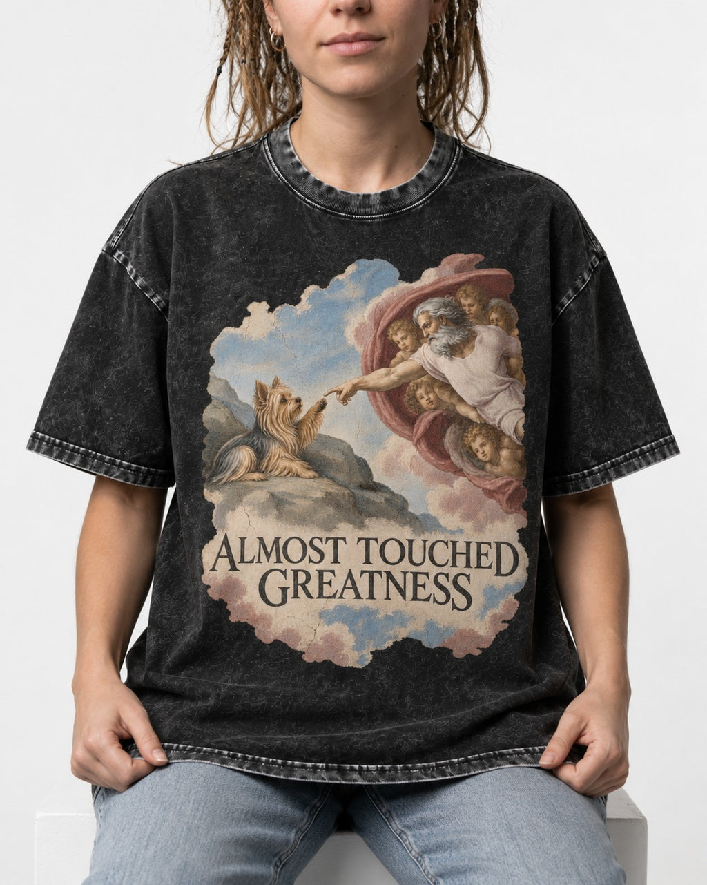 Yorkshire Terrier Almost Touched Greatness Creation Parody Graphic Washed Tee in Black, worn by a seated model