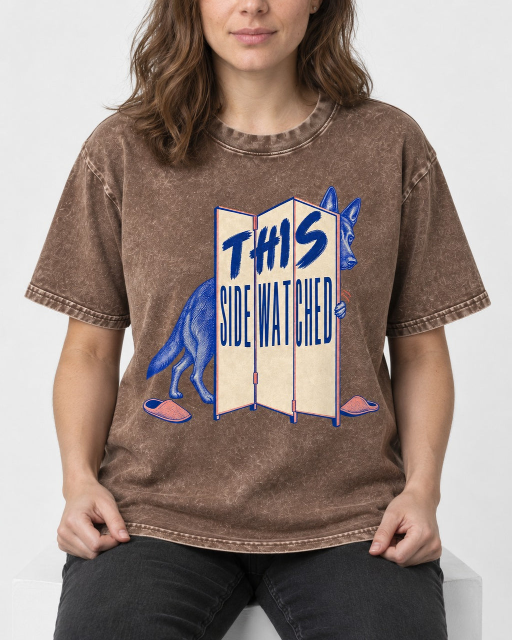 This Side Watched by German Shepherd Dog Washed Tee in Coffee, worn by a seated model