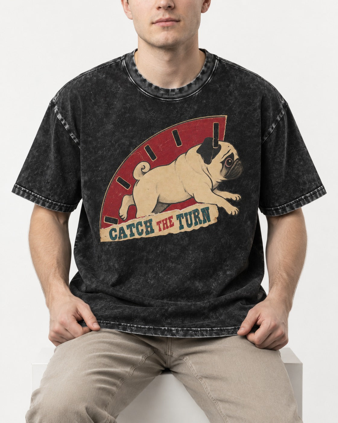 Pug Catch the Turn Track Graphic Washed Tee in Black, worn by a seated model