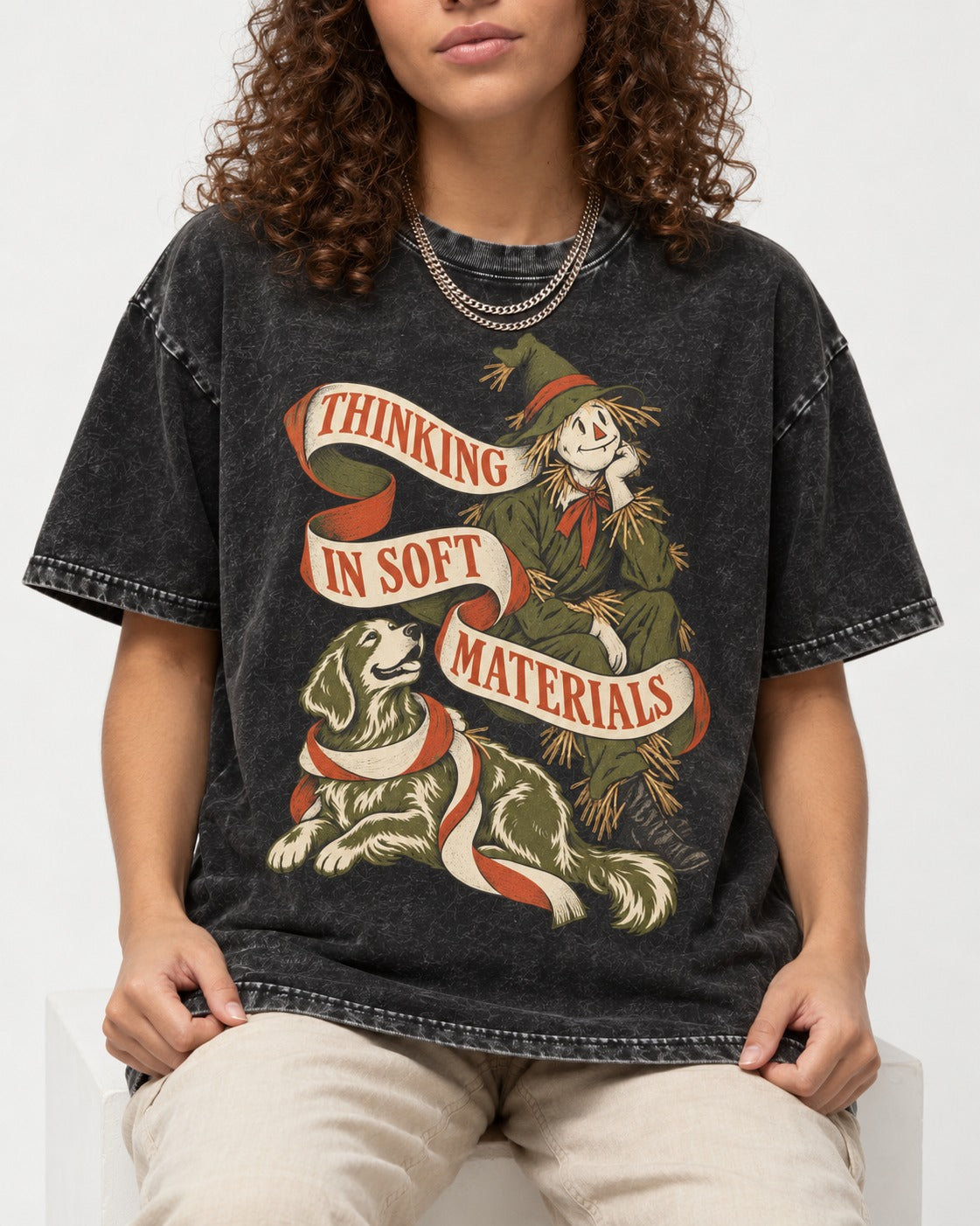 Golden Retriever Thinking in Soft Materials Scarecrow Graphic Washed Tee in Black, worn by a seated model