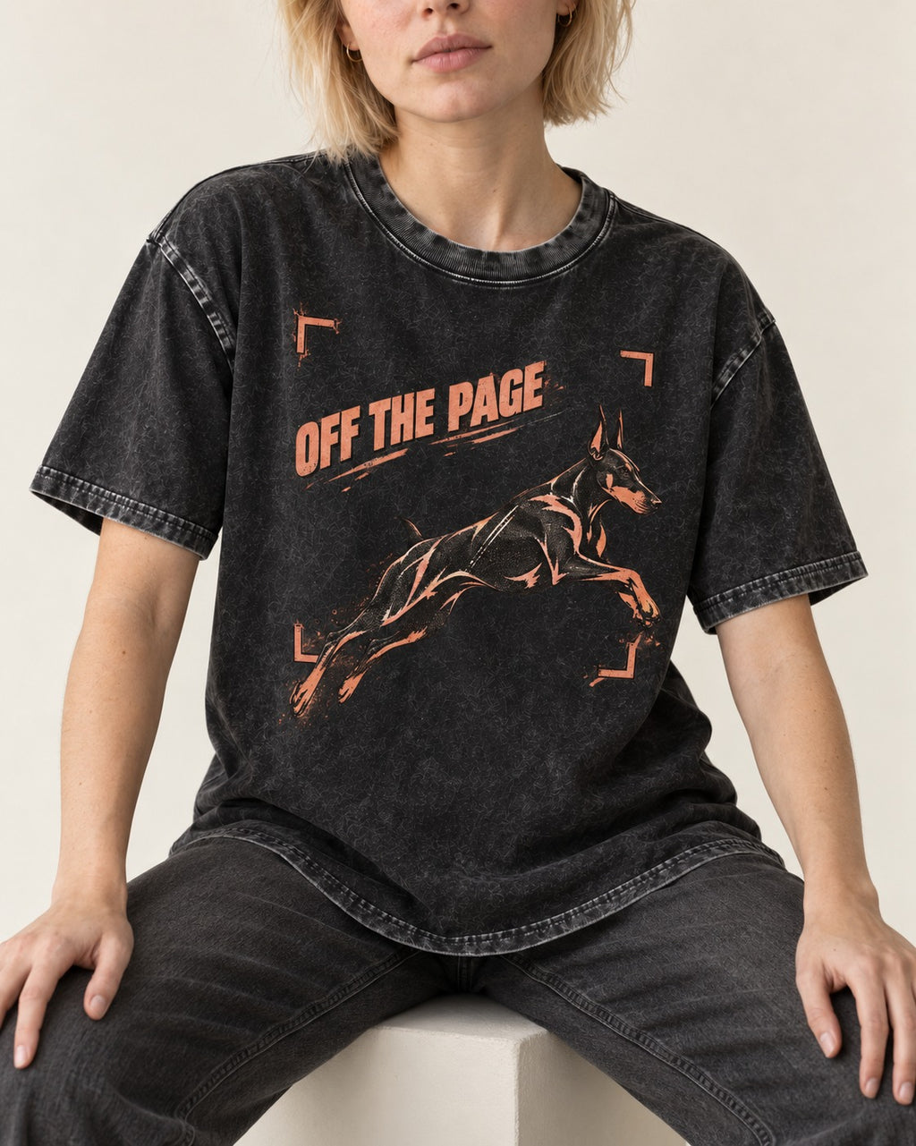 Doberman Off the Page Focus Frame Graphic Washed Tee in Black, worn by a seated model