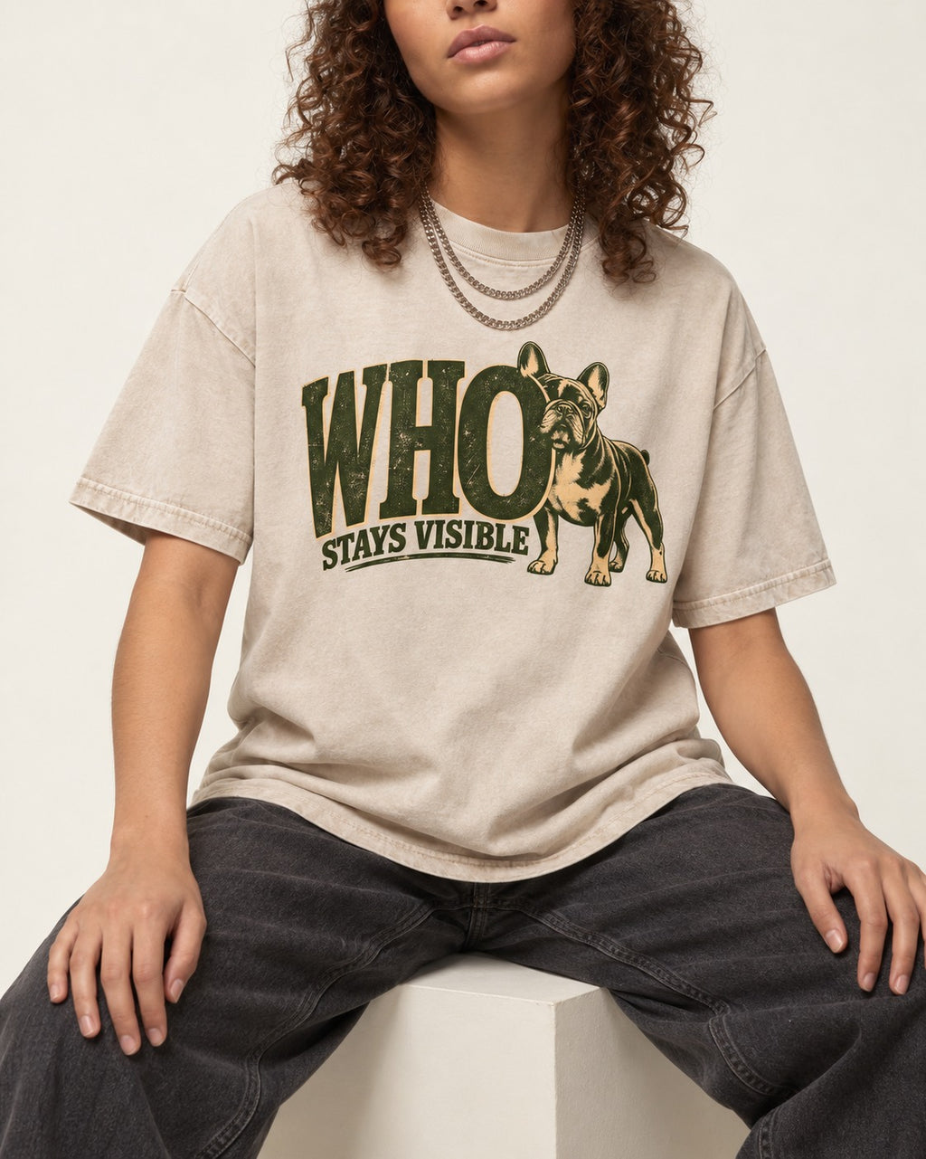 Frenchie Stays Visible Washed Tee in Apricot, worn by a seated model