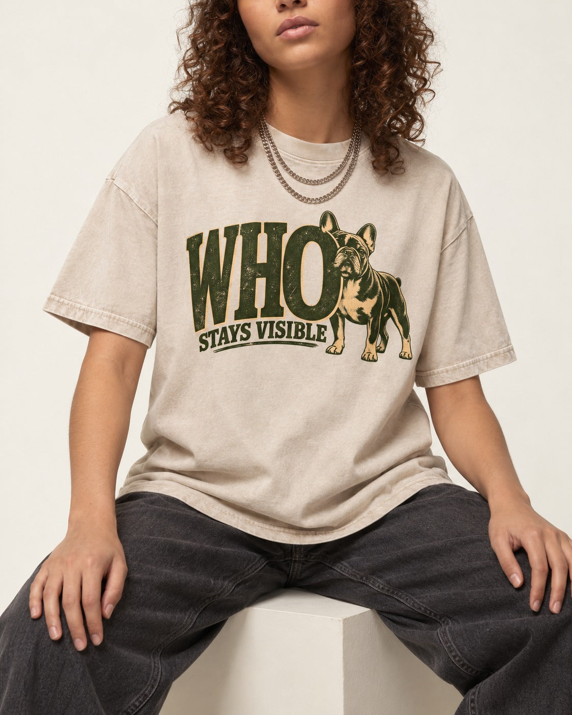Frenchie Stays Visible Washed Tee in Apricot, worn by a seated model