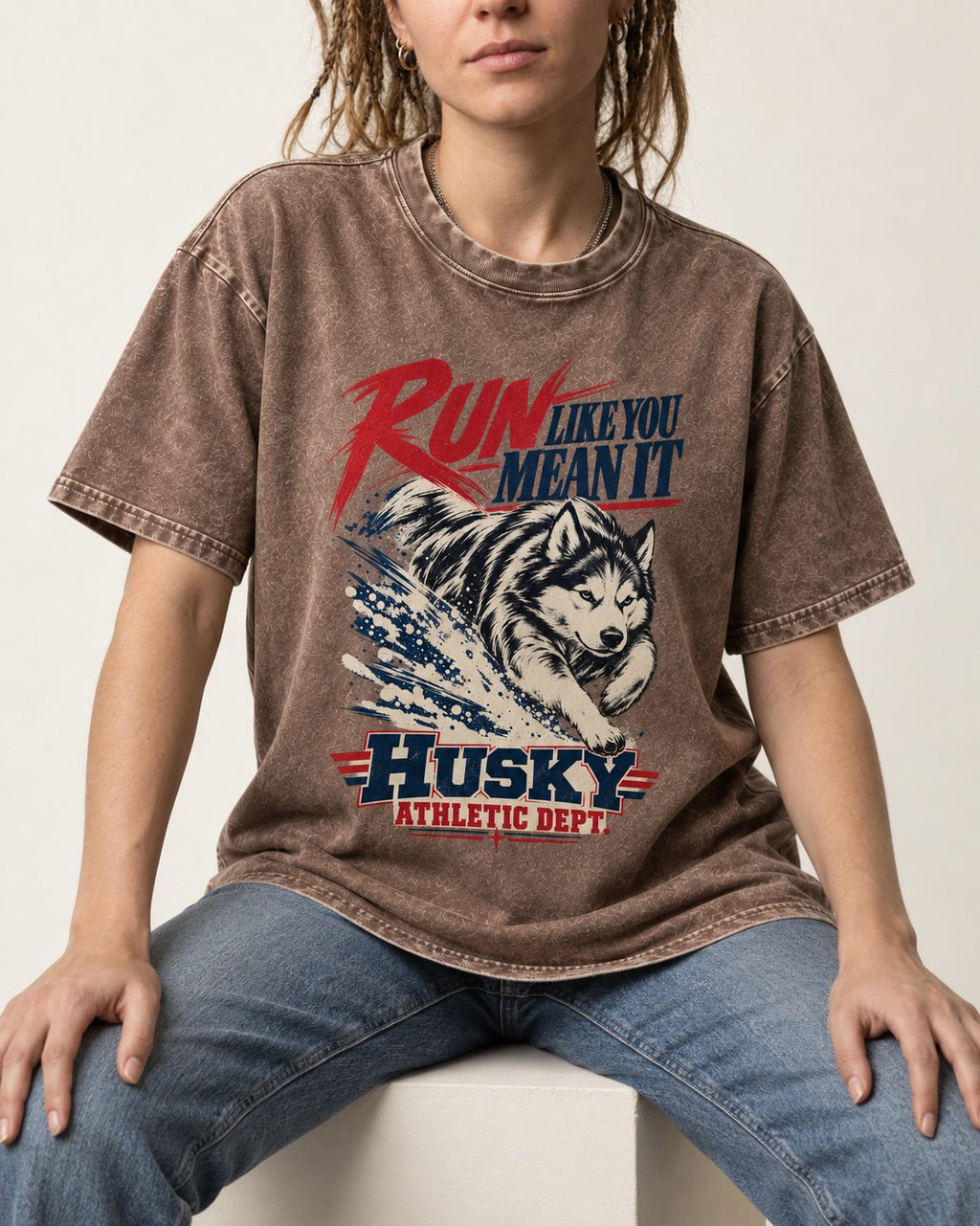 Husky Run with Purpose Washed Tee in Coffee, worn by a seated model