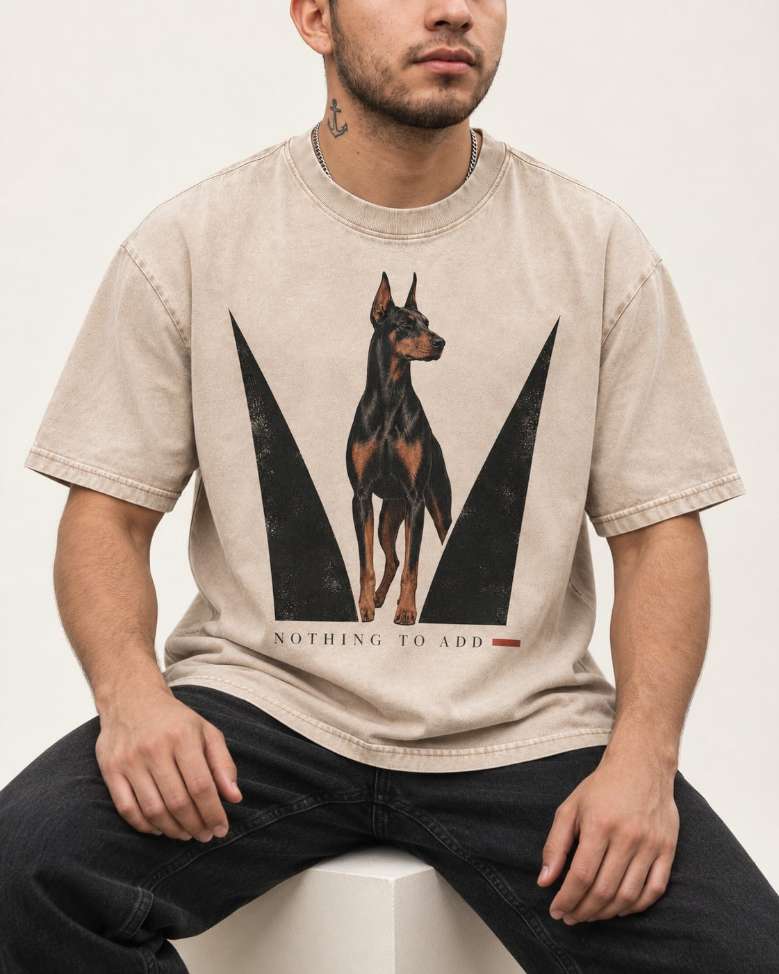Doberman Nothing to Add Washed Tee in Apricot, worn by a seated model