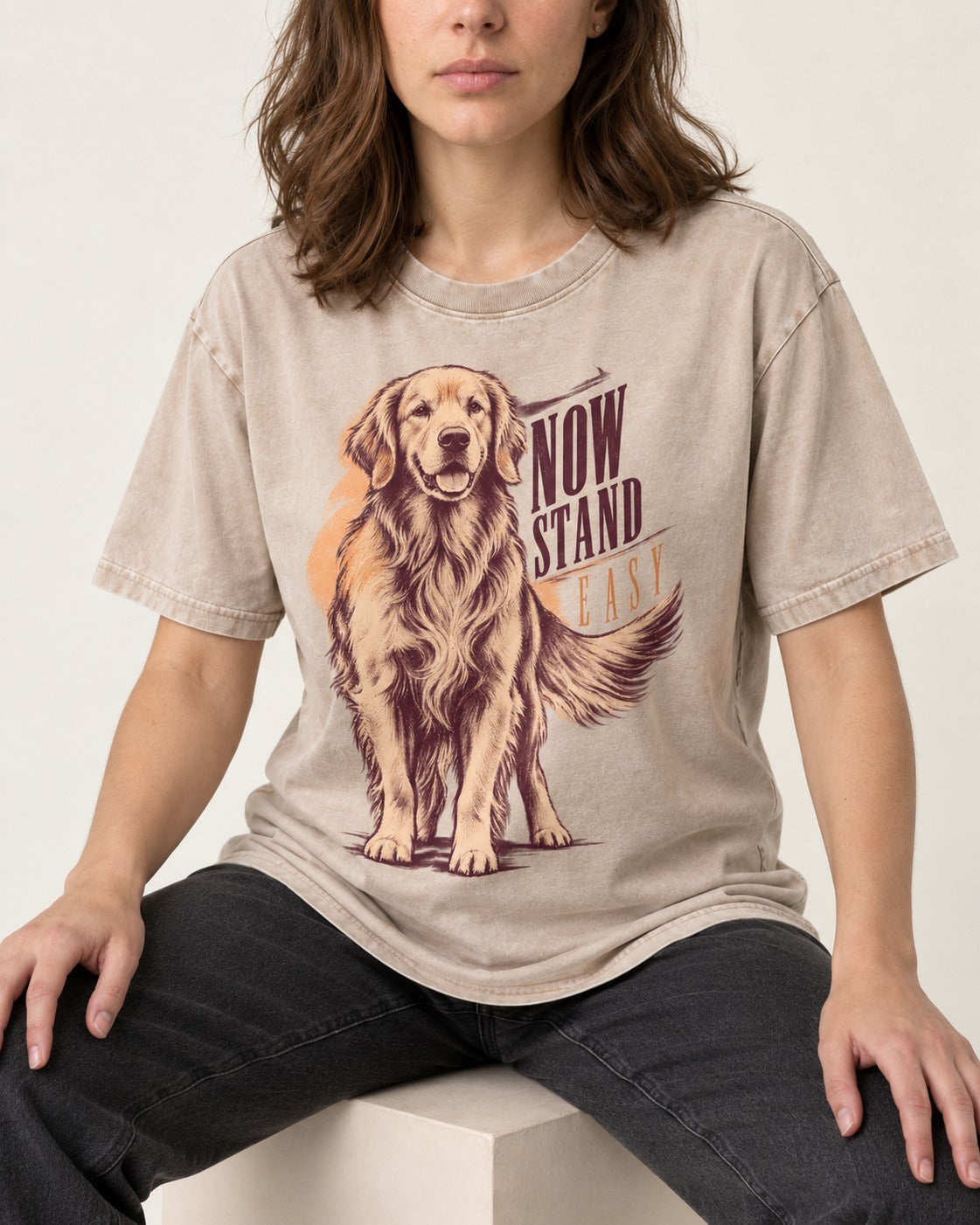 Now Stand Easy Golden Retriever Washed Tee in Apricot, worn by a seated model