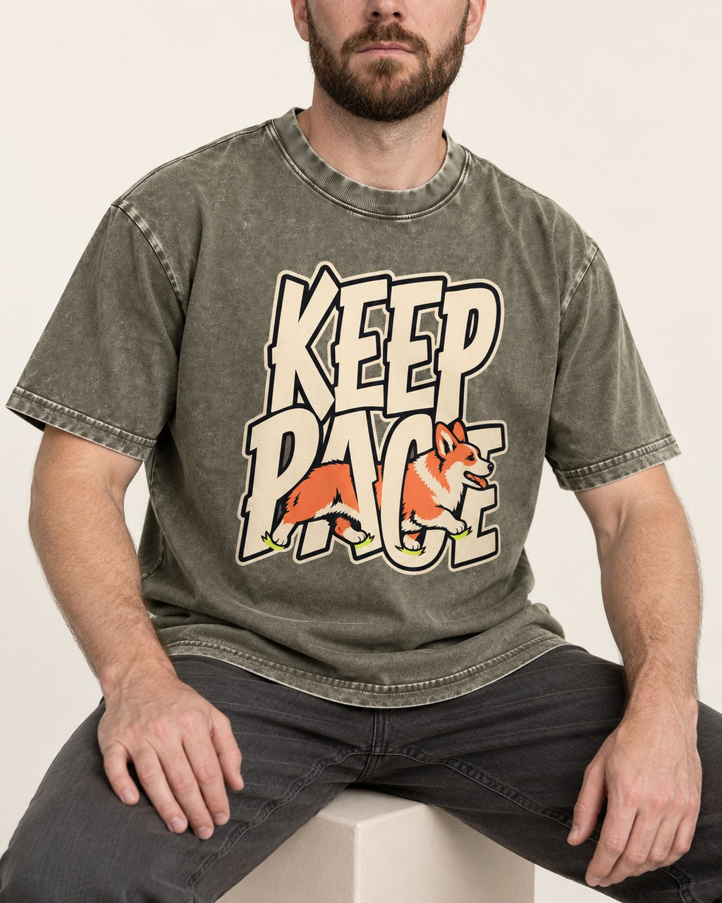 Corgi Keep Pace Running Typographic Graphic Washed Tee in Army Green, worn by a seated model