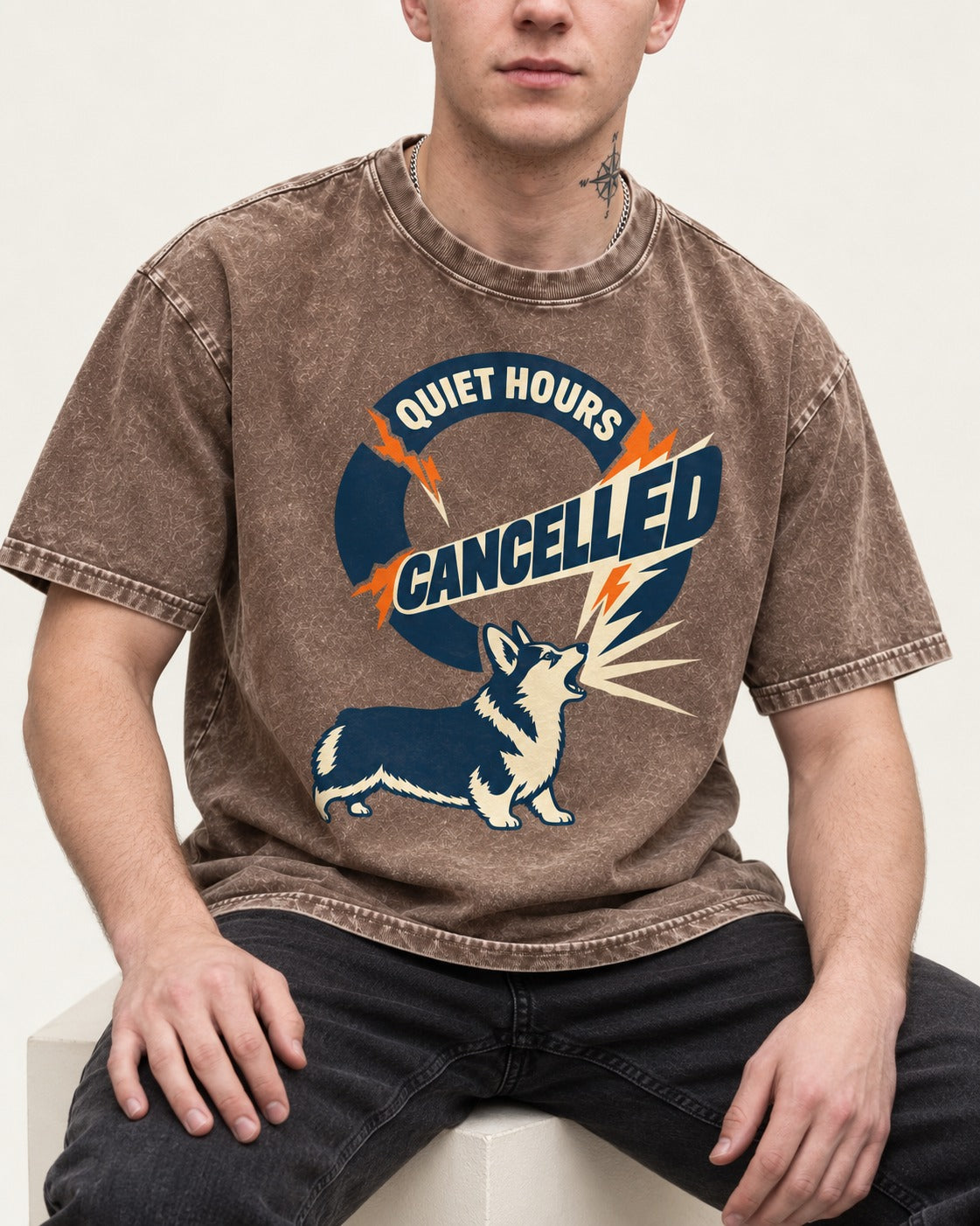 Corgi Quiet Hours Cancelled Calling Badge Graphic Washed Tee in Coffee, worn by a seated model