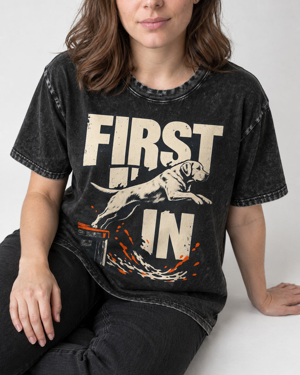 First In Dock Jump Labrador Retriever Graphic Washed Tee in Black, worn by a seated model