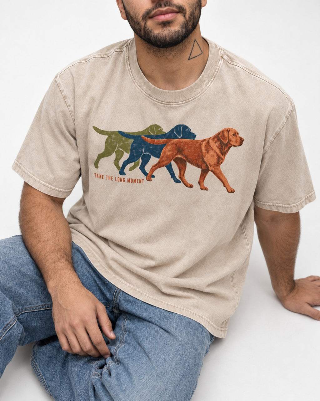 Take the Long Moment Labrador Retriever Washed Tee in Apricot, worn by a seated model