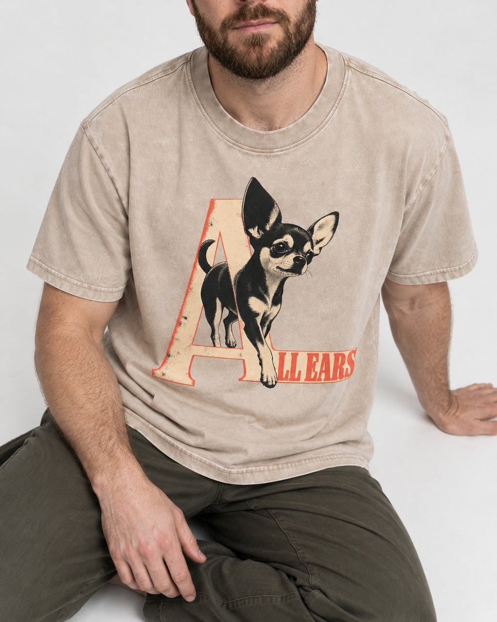 All Ears Chihuahua Washed Tee in Apricot, worn by a seated model
