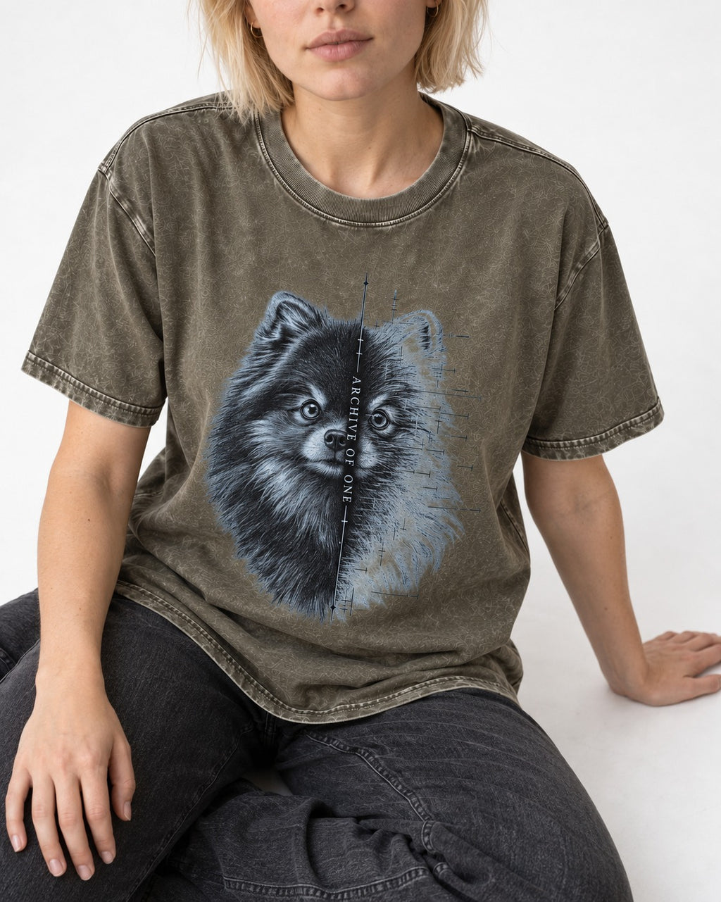 Pomeranian Archive of One Split Portrait Graphic Washed Tee in Army Green, worn by a seated model