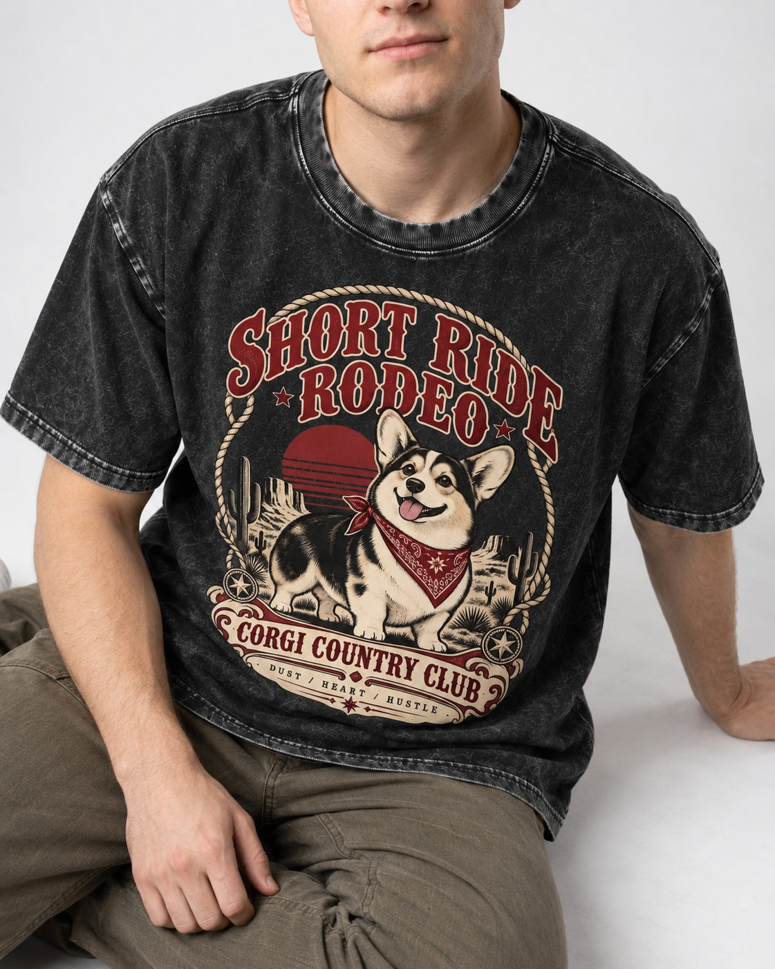 Corgi Short Ride Rodeo Country Club Badge Washed Tee in Black, worn by a seated model