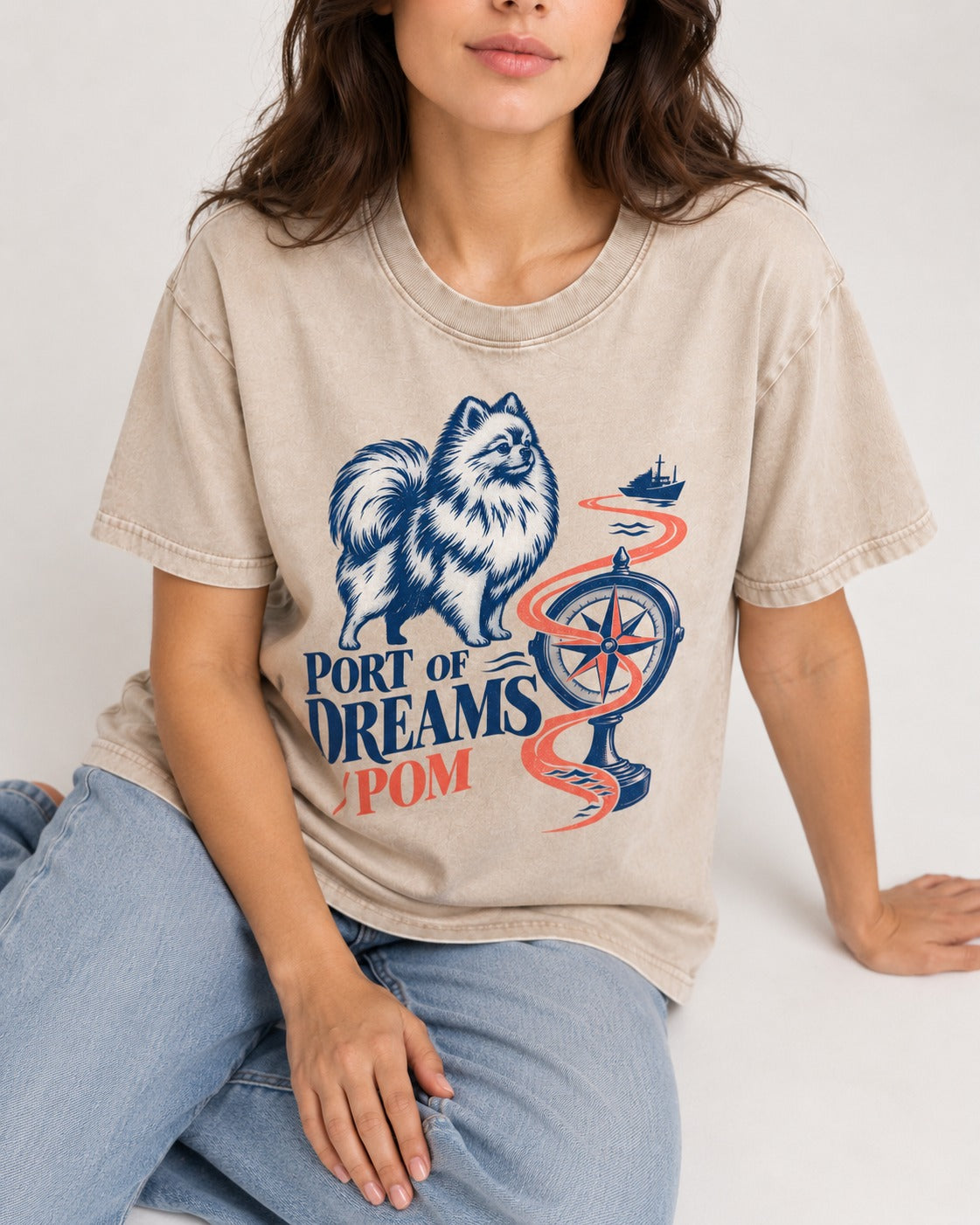 Pomeranian Port of Dreams Washed Tee in Apricot, worn by a seated model