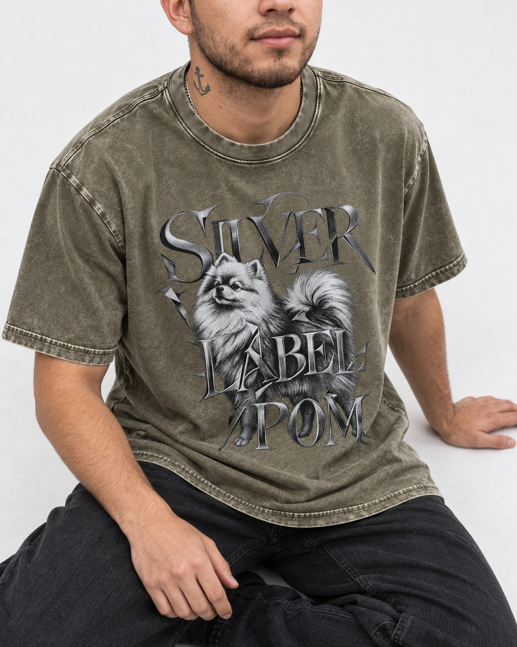 Pomeranian Silver Label Metallic Typography Graphic Washed Tee in Army Green, worn by a seated model