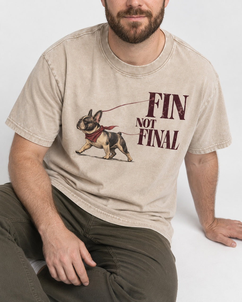 Frenchie Fin Not Final Washed Tee in Apricot, worn by a seated model
