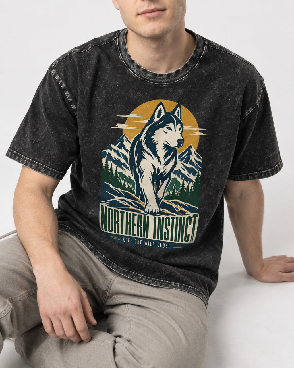 Husky Northern Instinct Mountain Sentinel Washed Tee in Black, worn by a seated model