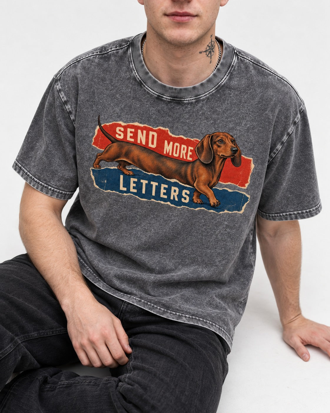 Dachshund Send More Letters Torn Paper Graphic Washed Tee in Gray, worn by a seated model