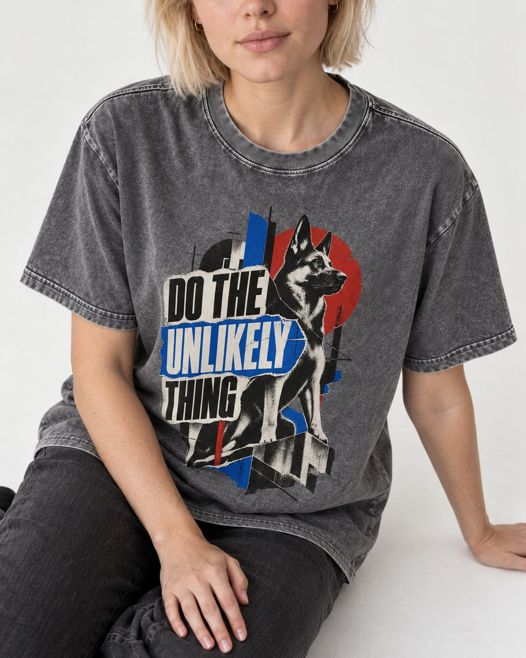 Do The Unlikely Thing Torn Poster German Shepherd Dog Graphic Washed Tee in Gray, worn by a seated model