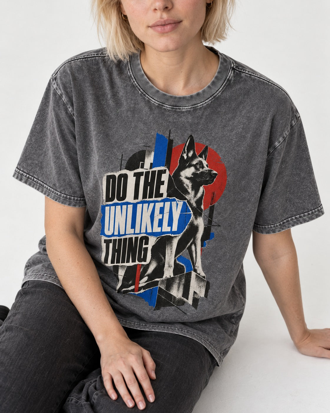 Do The Unlikely Thing Torn Poster German Shepherd Dog Graphic Washed Tee in Gray, worn by a seated model